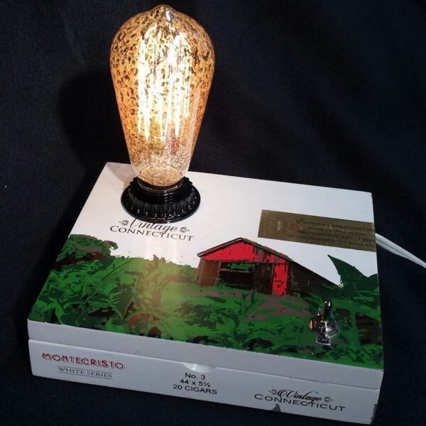 Montecristo cigar box lamp with vintage barn farm on top and a large Edison style bulb. White box with green and red design. A unique farm country gift.SL-431