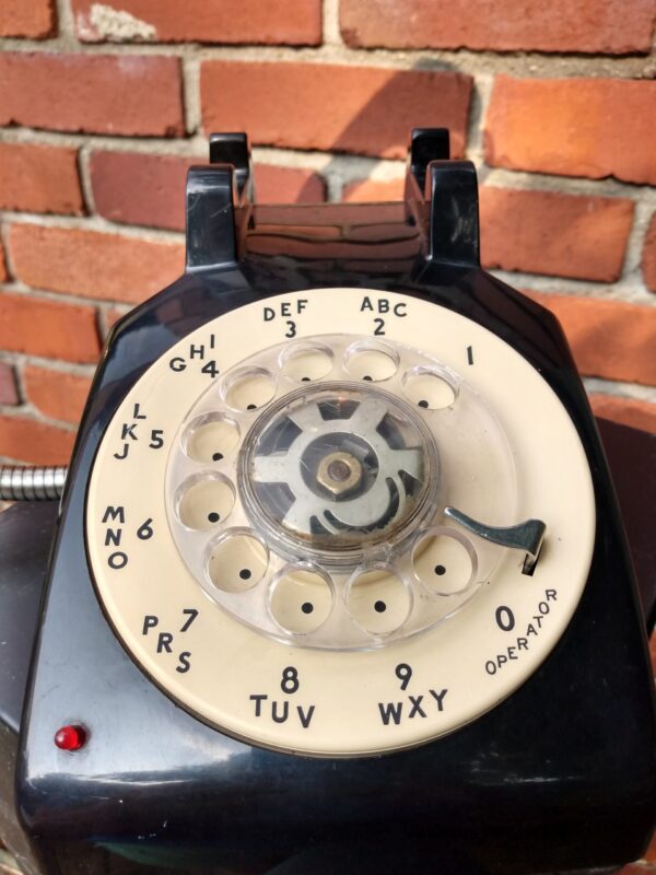 A two-woned cream and black vintage telephone that has two light bulbs coming out of the reciever handle. It's the perfect Wedding Gift!