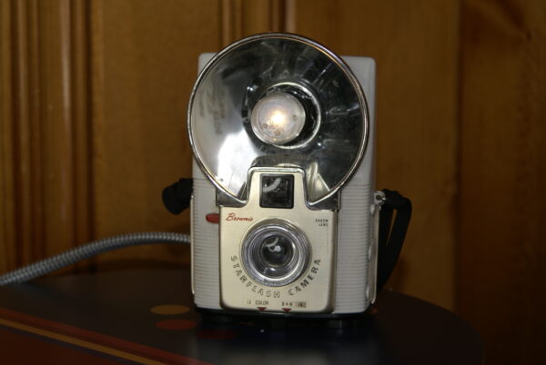 A vintage white in color Kodak Star Flash camera converted into a small table top lamp, perfect for a book shelf